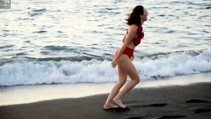 Eve shows off her beautiful breasts at the beach